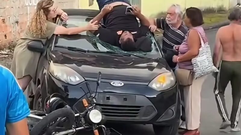 Acidente impressionante destrói carro e arremessa motociclista sobre o capô; veja vídeo
